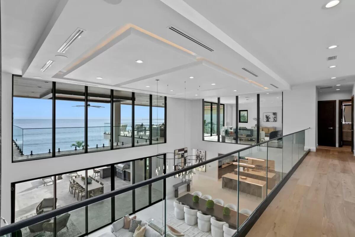 Admire the Seamless Glass Railings and Open Ocean Views from This Upper Landing