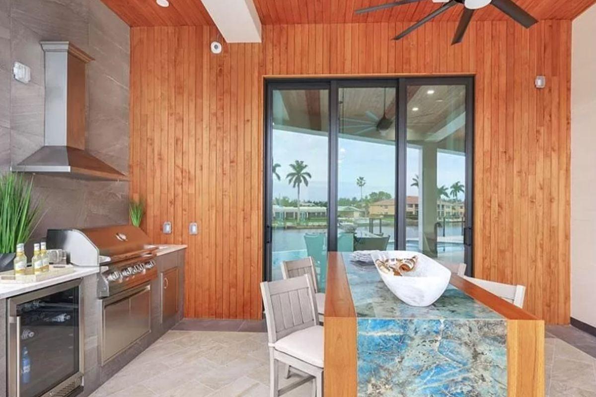 Outdoor Kitchen with Striking Stone Countertop and Canal View
