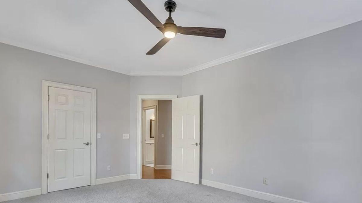 Classic Trim and a Sleek Fan in This Neutral-Hued Room