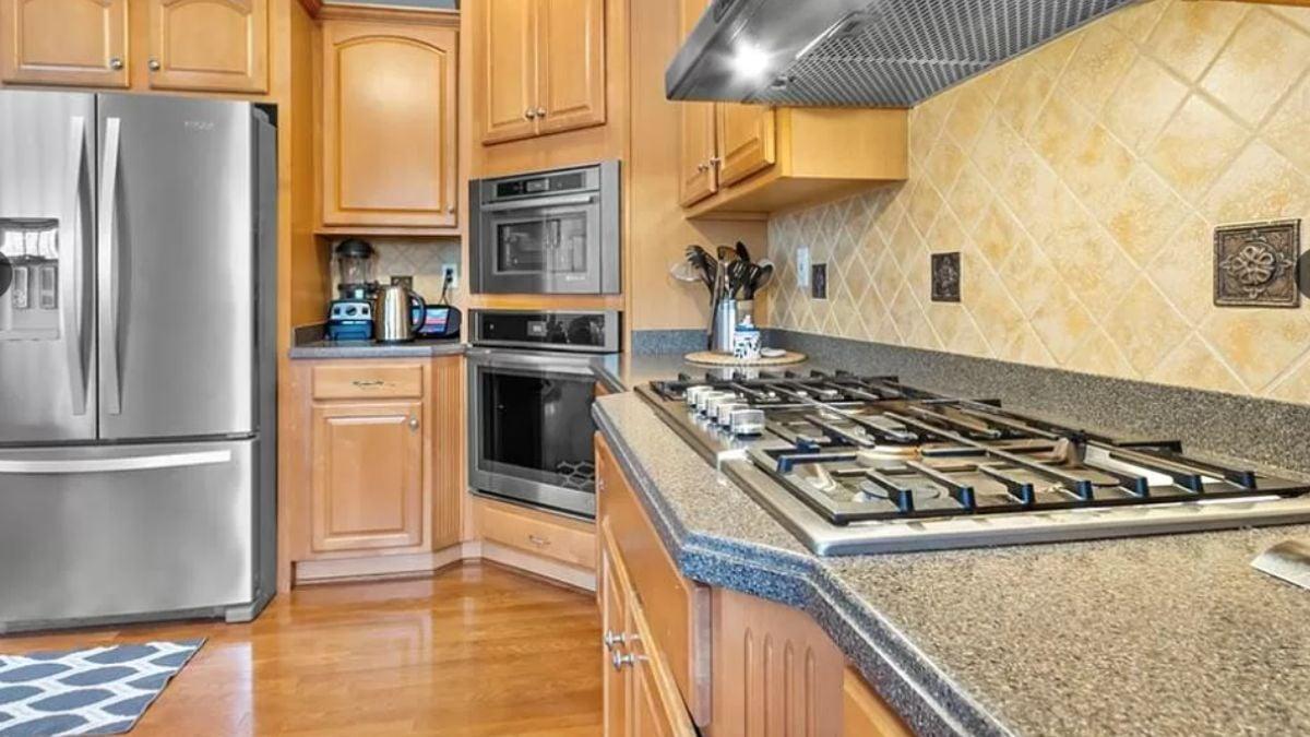 Check Out These Warm Wooden Cabinets and Practical Double Ovens
