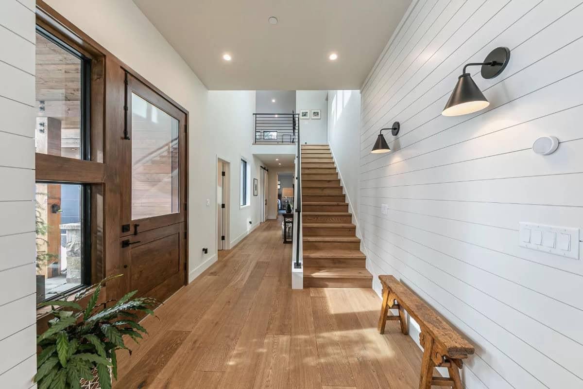 Wow, Check Out That Striking Wood Door and Modern Lighting Combo in This Entryway