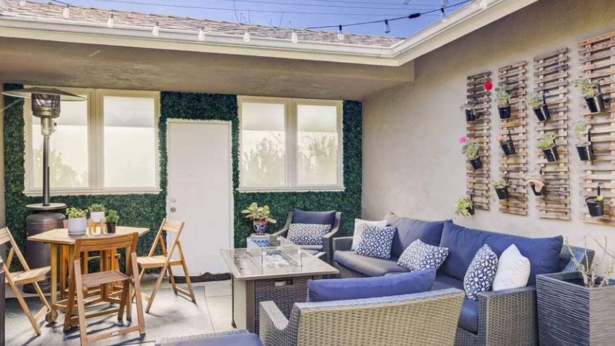 Outdoor Lounge with Vertical Planters Elevating the Wall Design