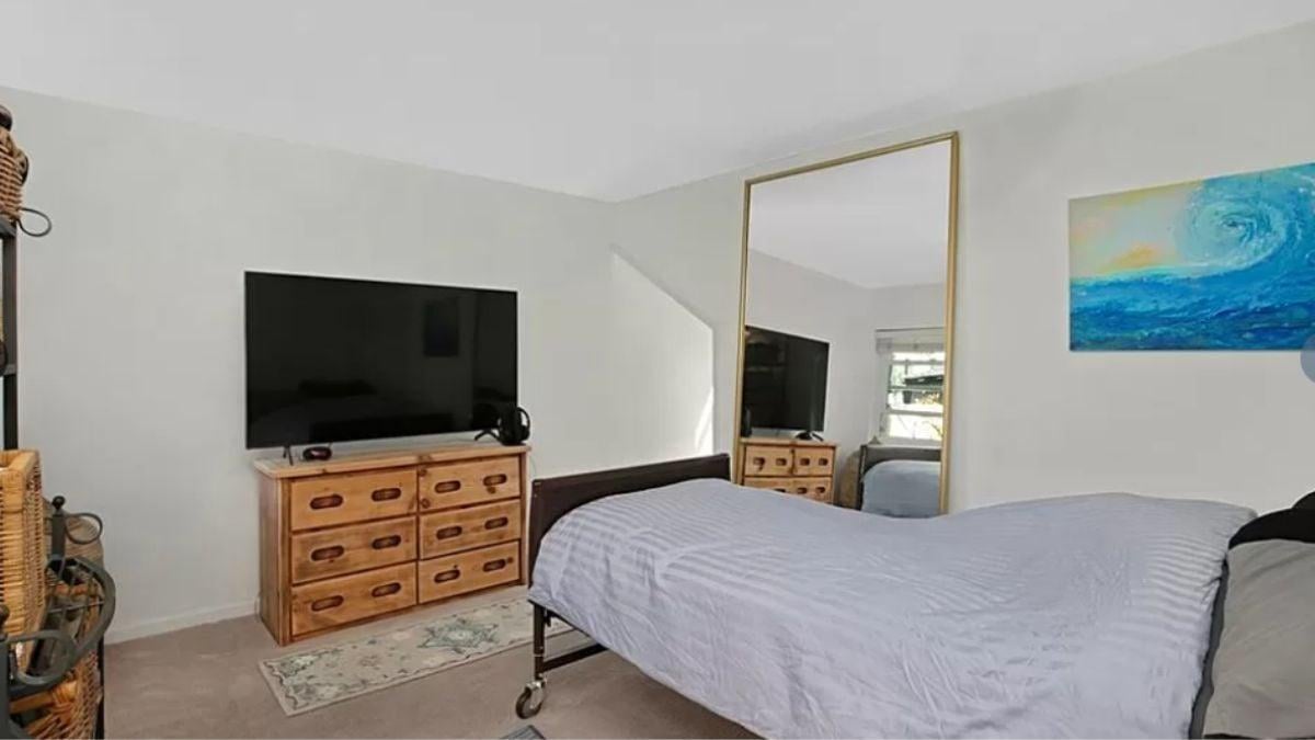 Spot the Oversized Mirror Enhancing This Bedroom