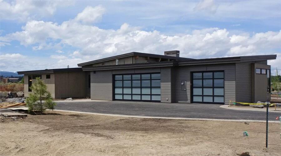 Notice the Expansive Garage Doors and Clean Lines in This Modern Home