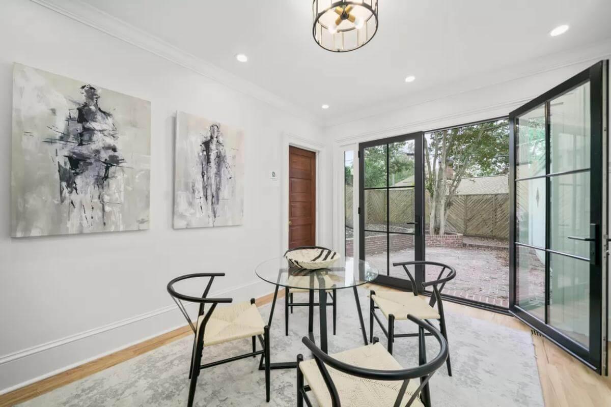 Notice the Elegant Black Framed Doors in This Bright Dining Space