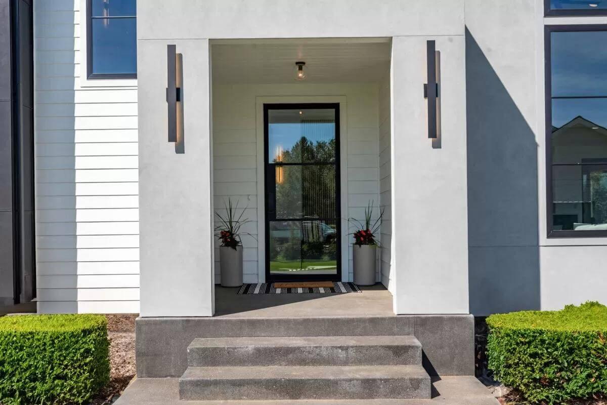 Minimalist Entryway with Linear Lighting and Symmetrical Planters