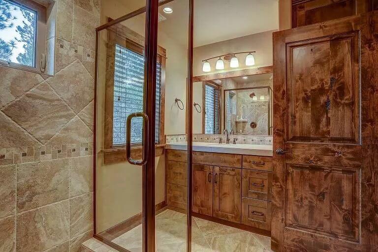 Cozy Craftsman Bathroom with Beautiful Wood Vanity and Stone Tile