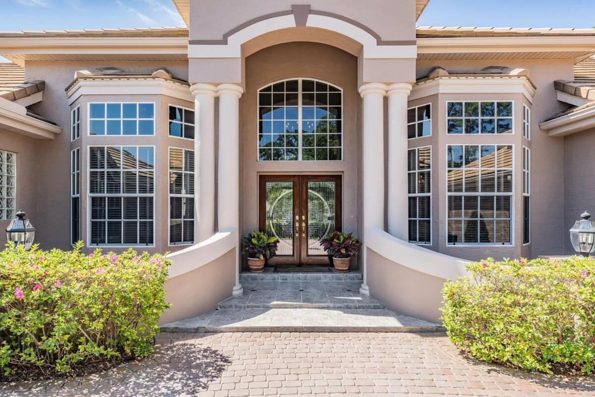 Grand Entryway with Twin Columns and Expansive Bay Windows