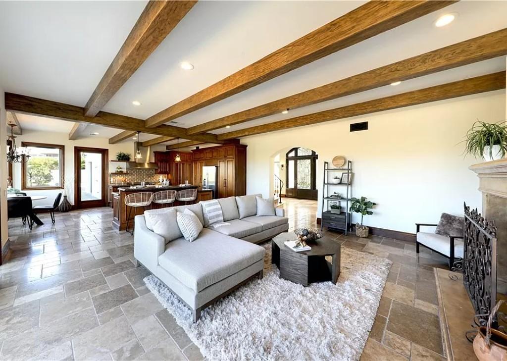 Admire the Open-Concept Living Area with Its Inviting Exposed Beams