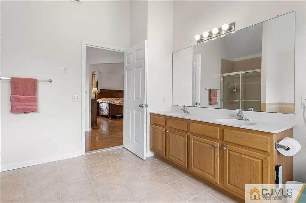 Double Vanity and Spacious Mirror in This Bright Bathroom