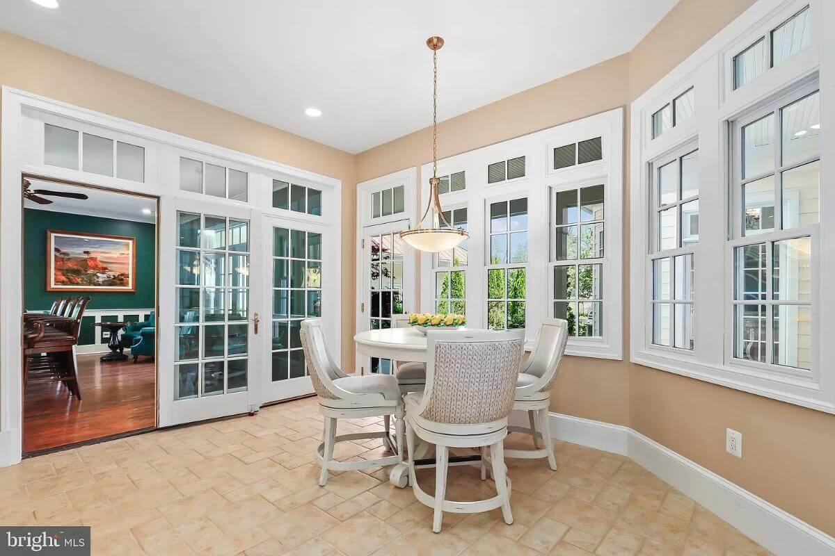 Cozy Breakfast Nook Surrounded by French Doors and Windows