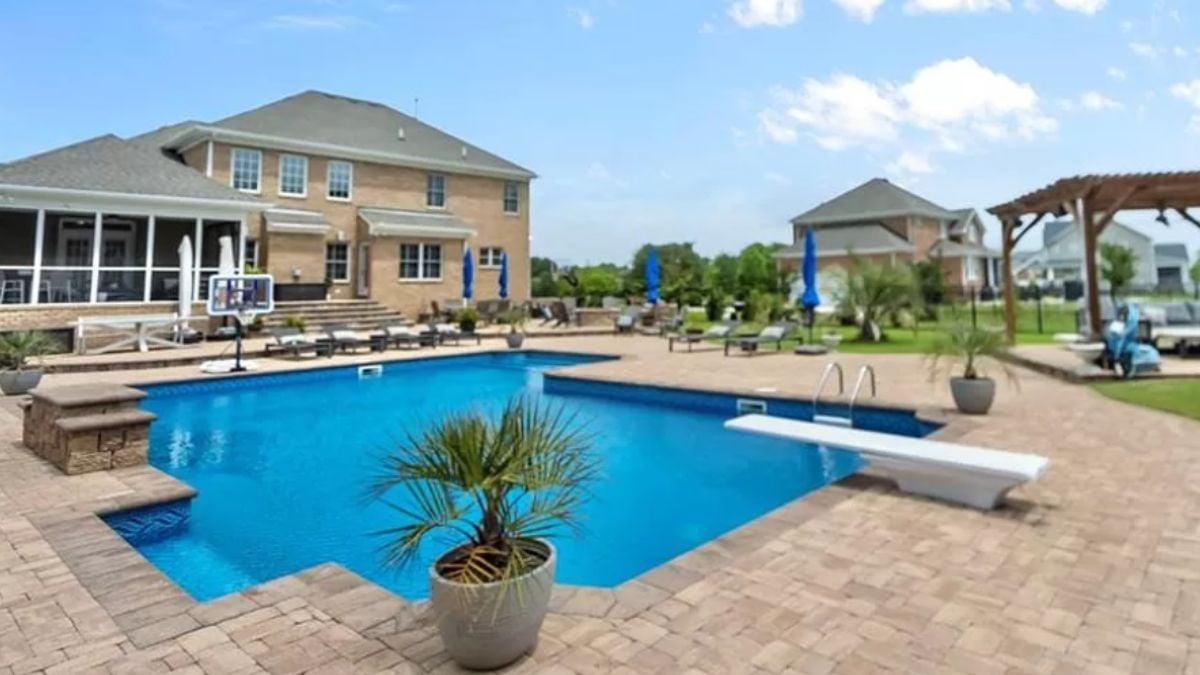 Dive into This Backyard Pool with Expansive Brick Surround