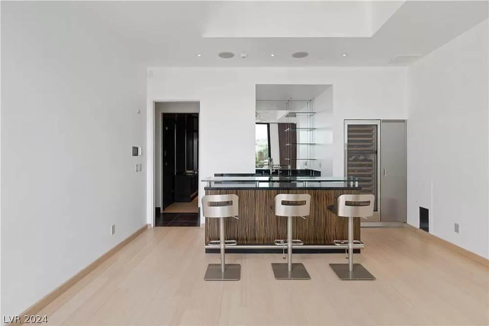 Modern Bar with Sleek Glass Shelving and Chic Stools