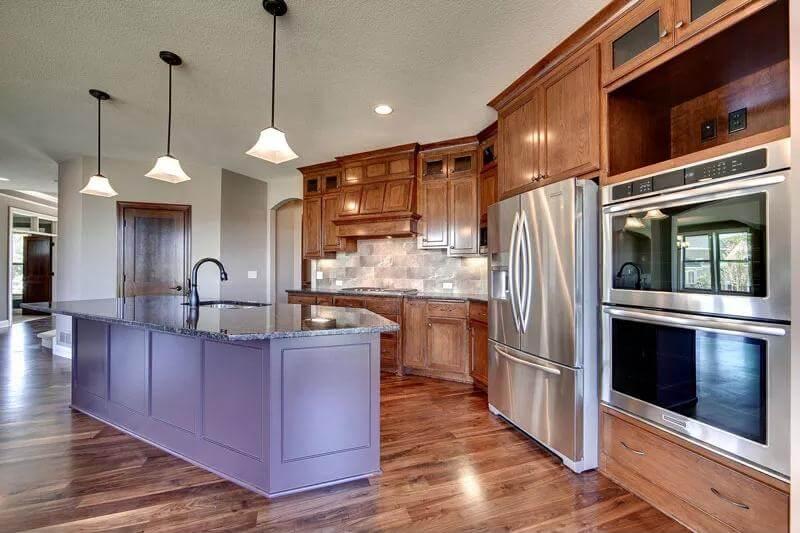 Notice the Rich Wood Cabinetry and Stainless Steel Appliances in This Craftsman Kitchen
