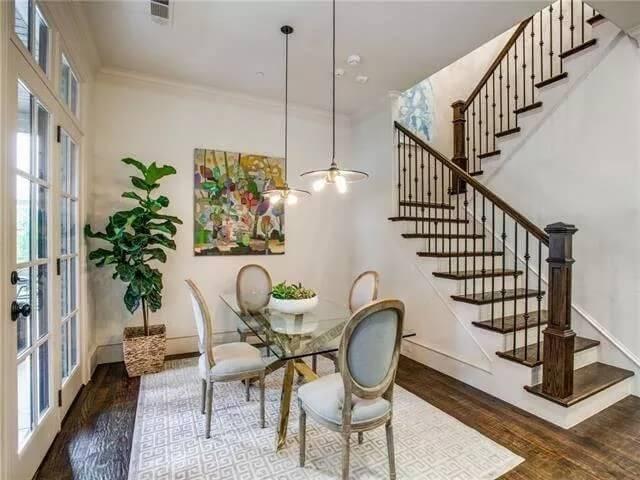 Check Out This Dining Area with Artistic Flair next to a Detailed Stairway