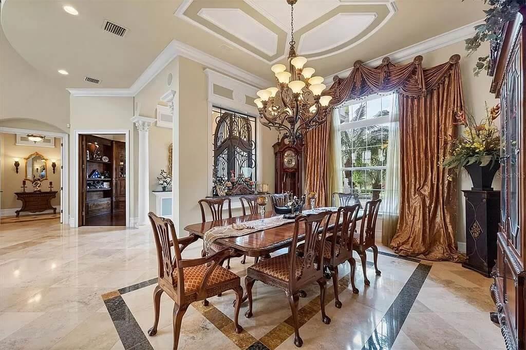 Grand Dining Room with an Impressive Coffered Ceiling and Ornate Chandelier