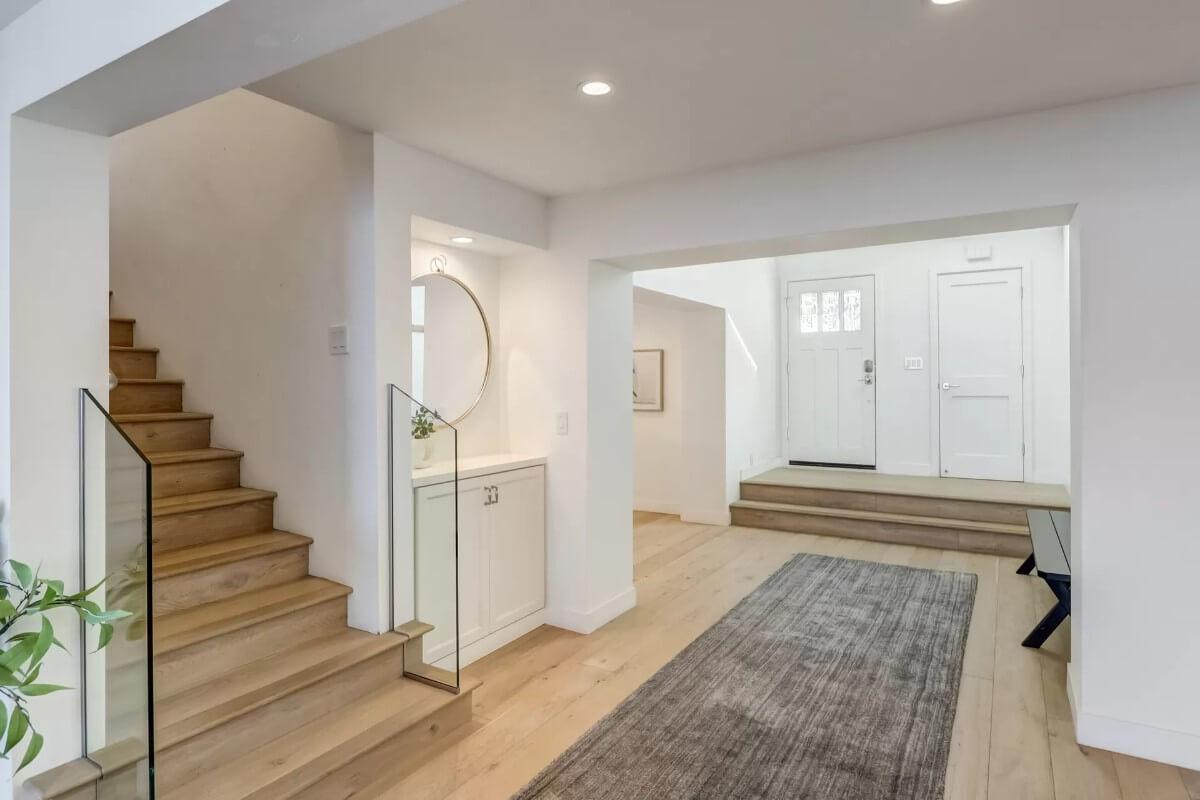 Minimalist Entryway Featuring a Striking Circular Mirror