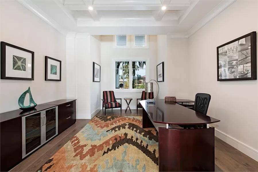 Home Office with Vibrant Rug and Coffered Ceiling Details