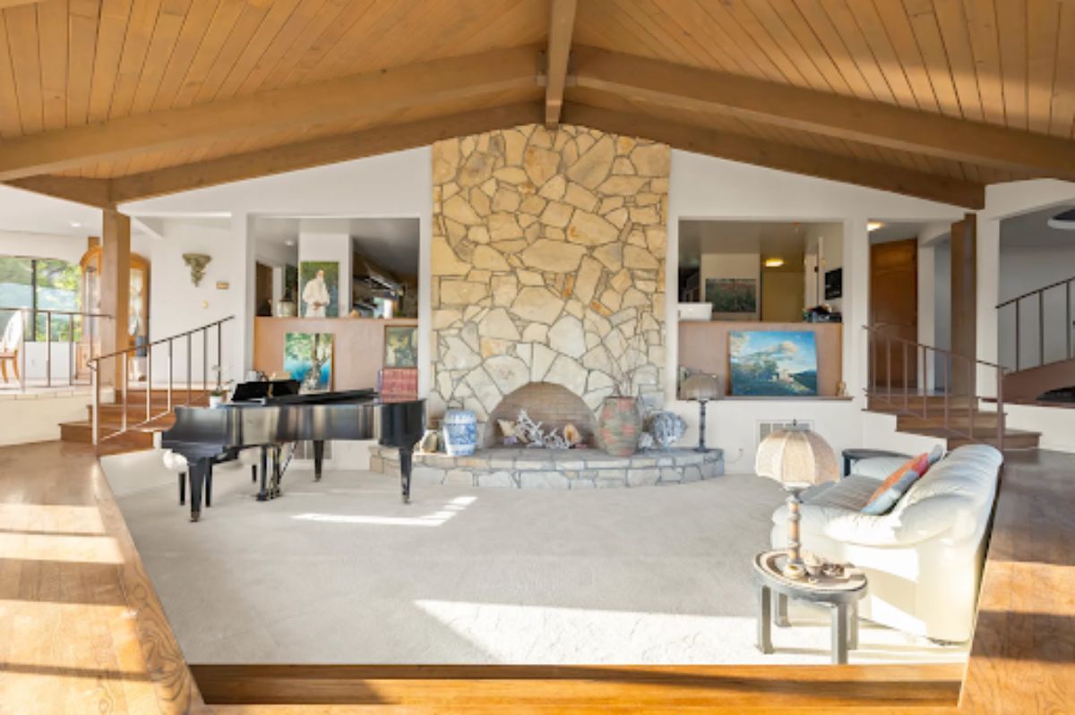 The sunken living room includes 20' beamed vaulted ceilings.
