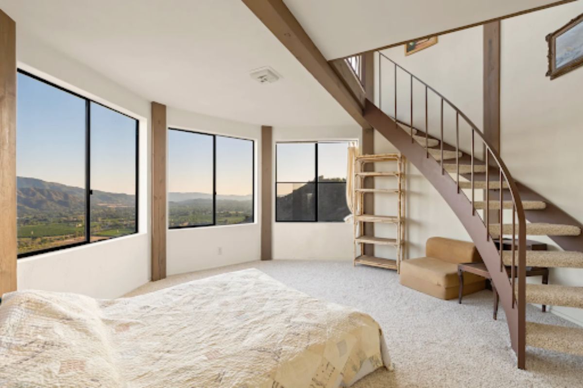 This extra room under the staircase features large windows that allow natural light
