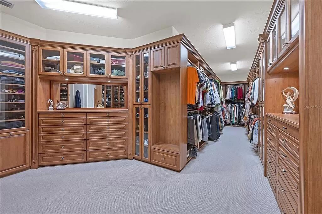 Notice the Expansive Custom Cabinets in This Luxurious Walk-In Closet