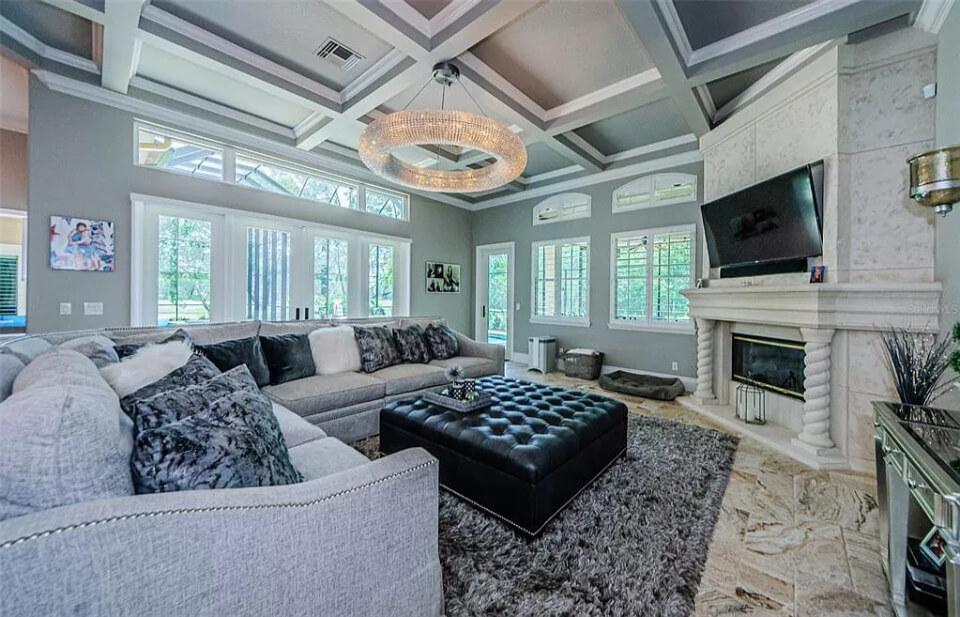 Impressive Living Room with a Statement Chandelier and Luxurious Fireplace