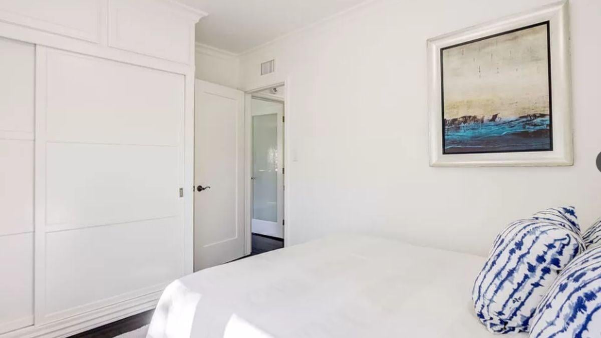 Minimalist Bedroom with Striking Blue Accents and Functional Storage