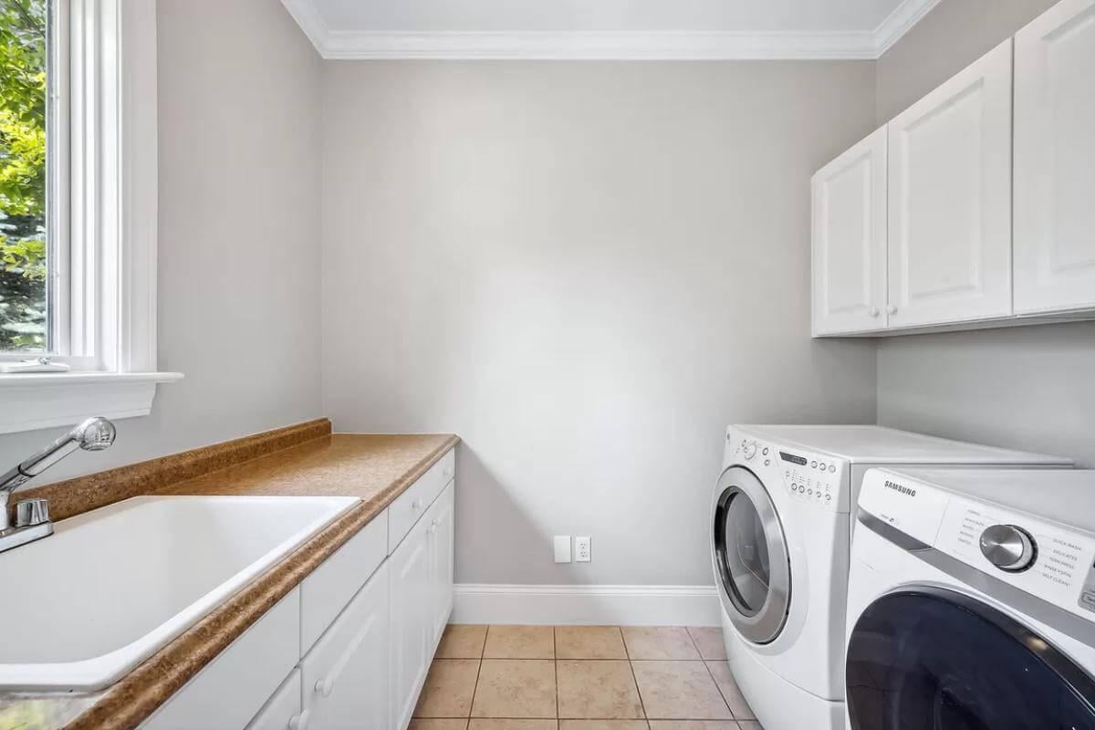 Practical Laundry Room with Handy Wall Cabinetry