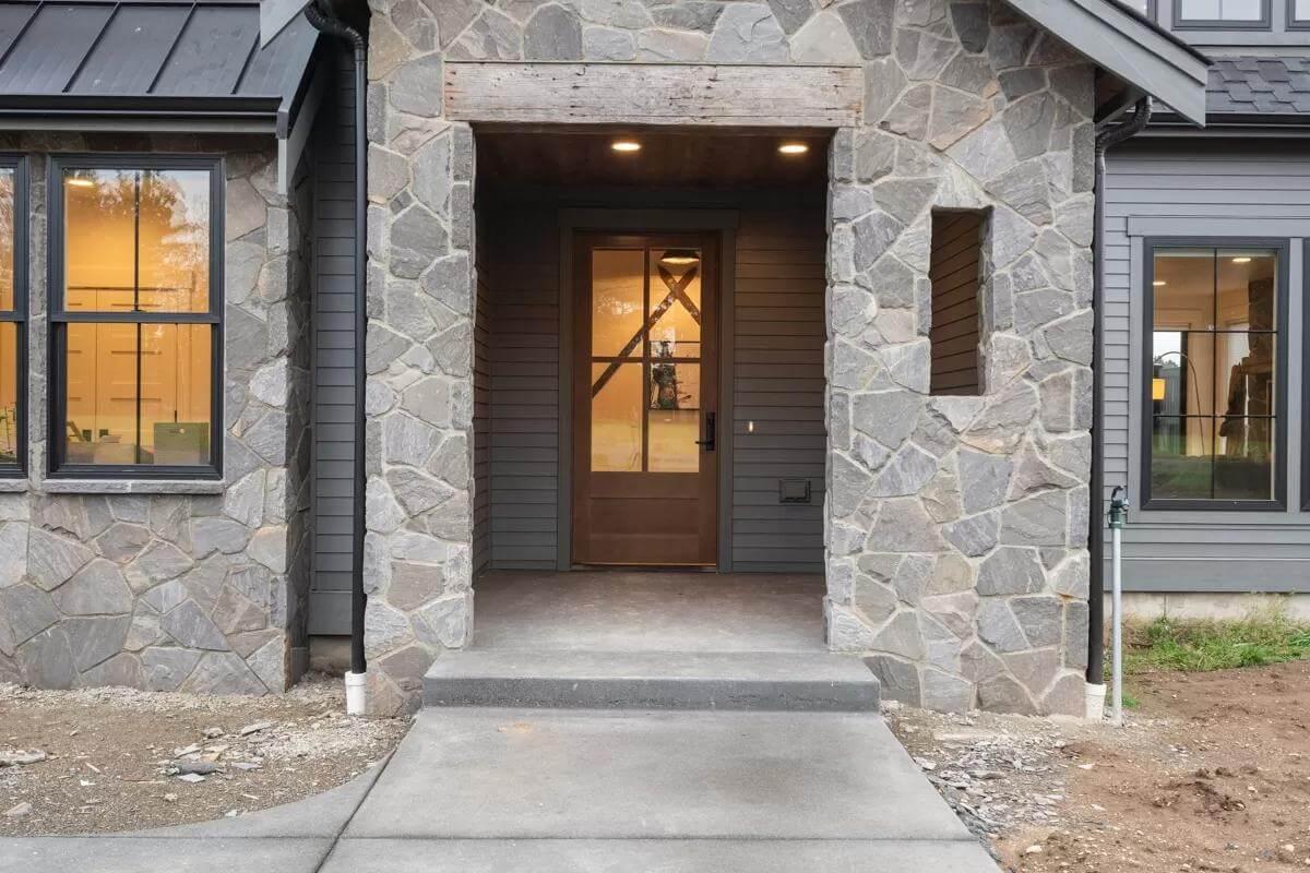 Craftsman Entryway with Bold Stonework and Warm Lighting