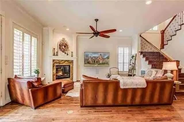 Warm Living Room with a Rustic Touch and Grand Staircase