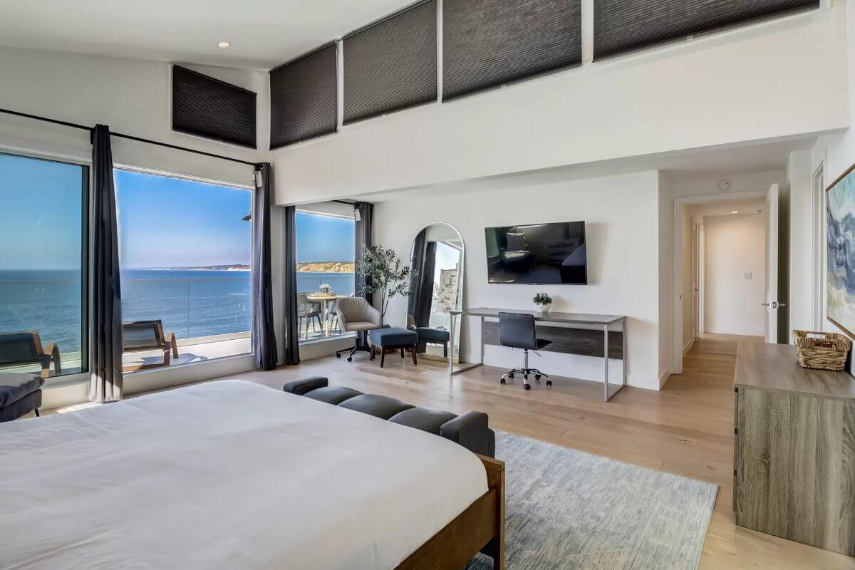 Oceanfront Bedroom with a Full-Wall Window and Mirror Touch