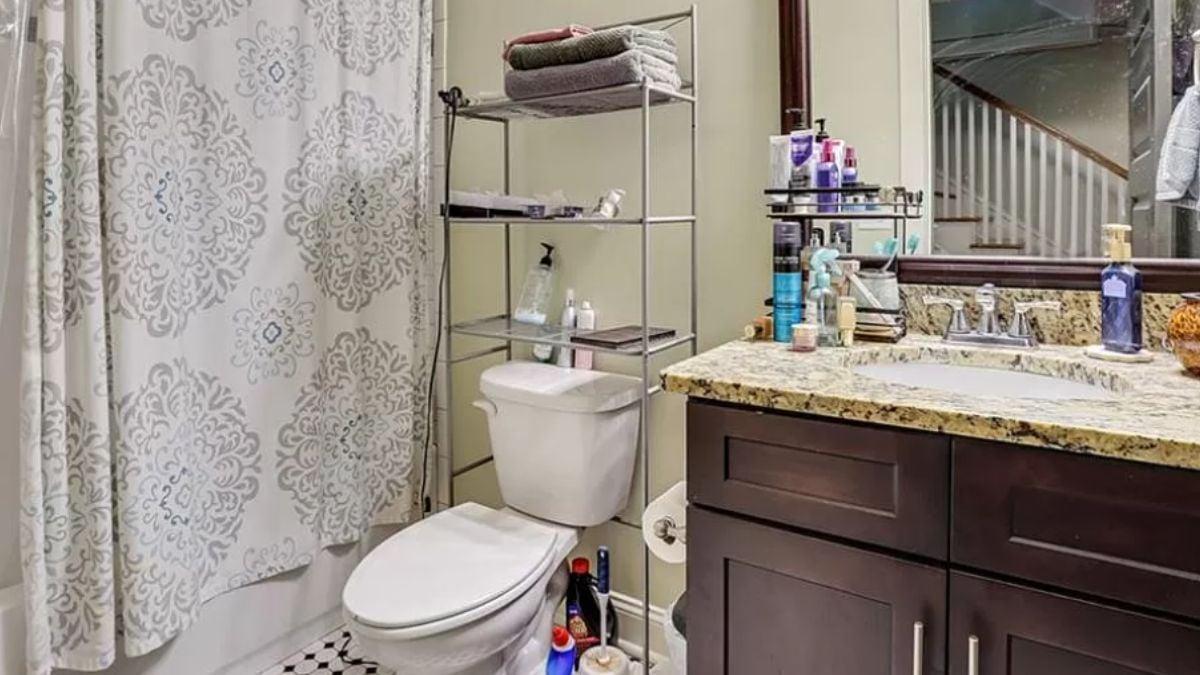 Notice the Granite Vanity Against Rich Cabinetry in This Compact Bathroom