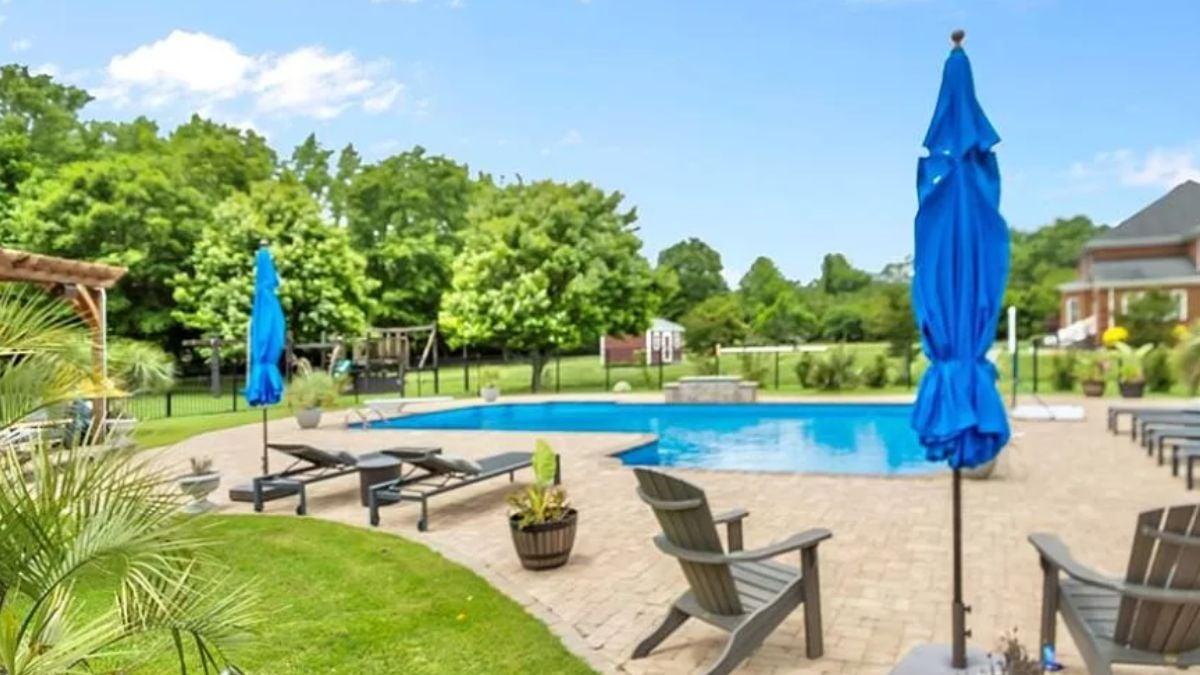 Chill by the Pool with a View of Lush Greens and Blue Skies