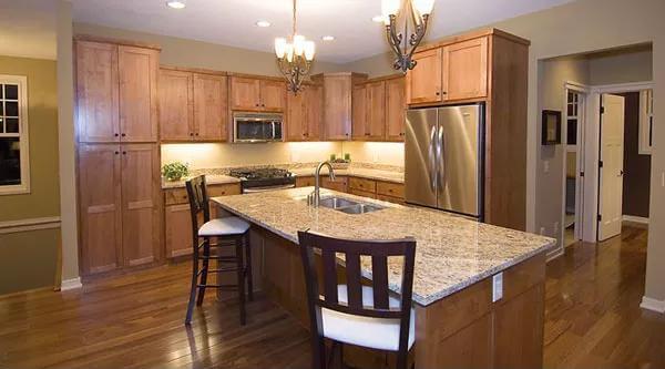 Spacious Craftsman Kitchen with Granite Island and Classic Wood Cabinets