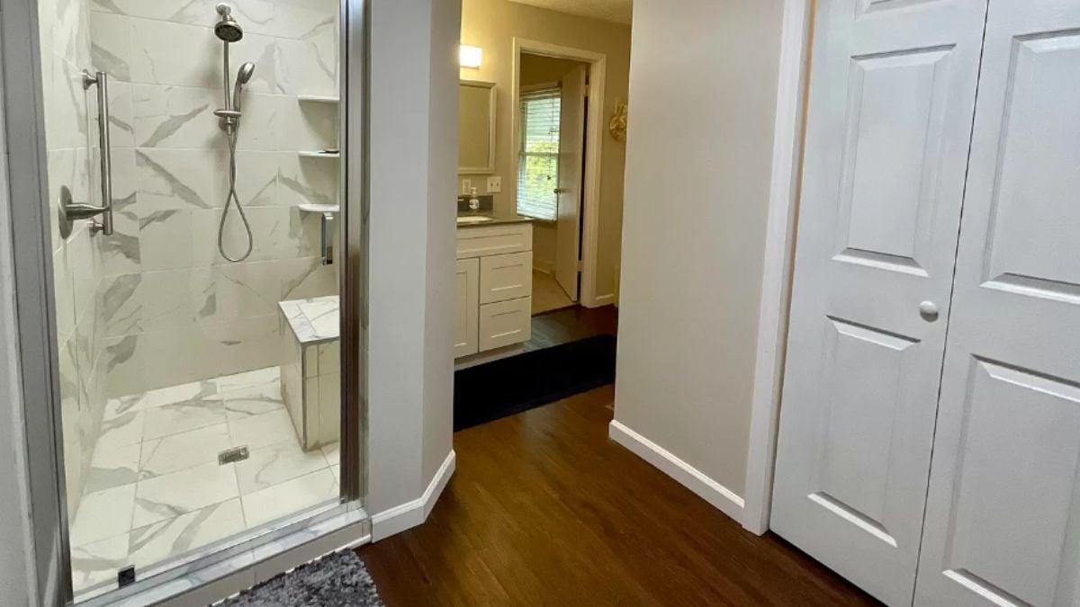 Modern Shower Stall with Sleek Marble Tiles and Built-In Bench