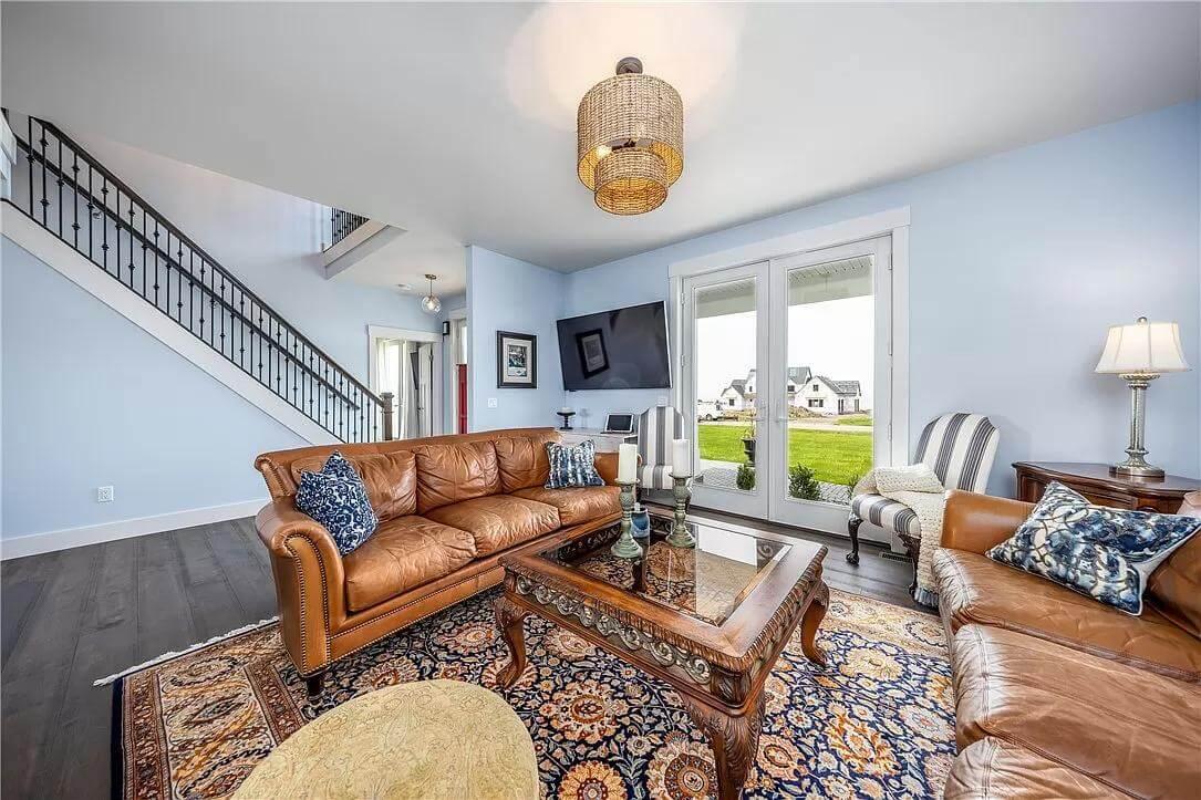 Notice the Warm Leather Sofas and Bold Blue Accents in This Living Room