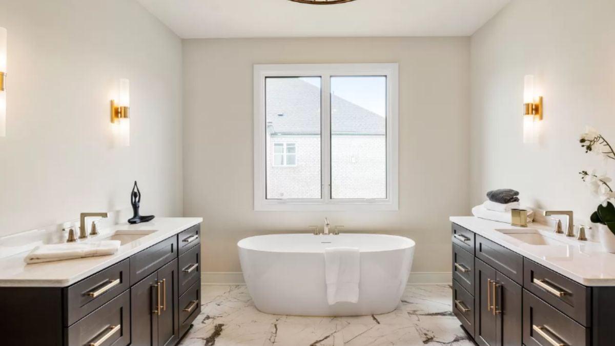Marvel at the Freestanding Tub Framed by Elegant Vanities