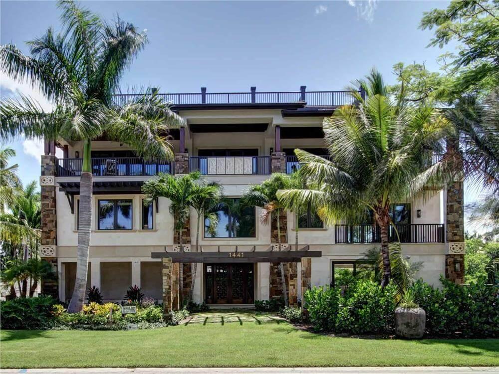 Tropical Oasis Featuring a Striking Pergola Entrance