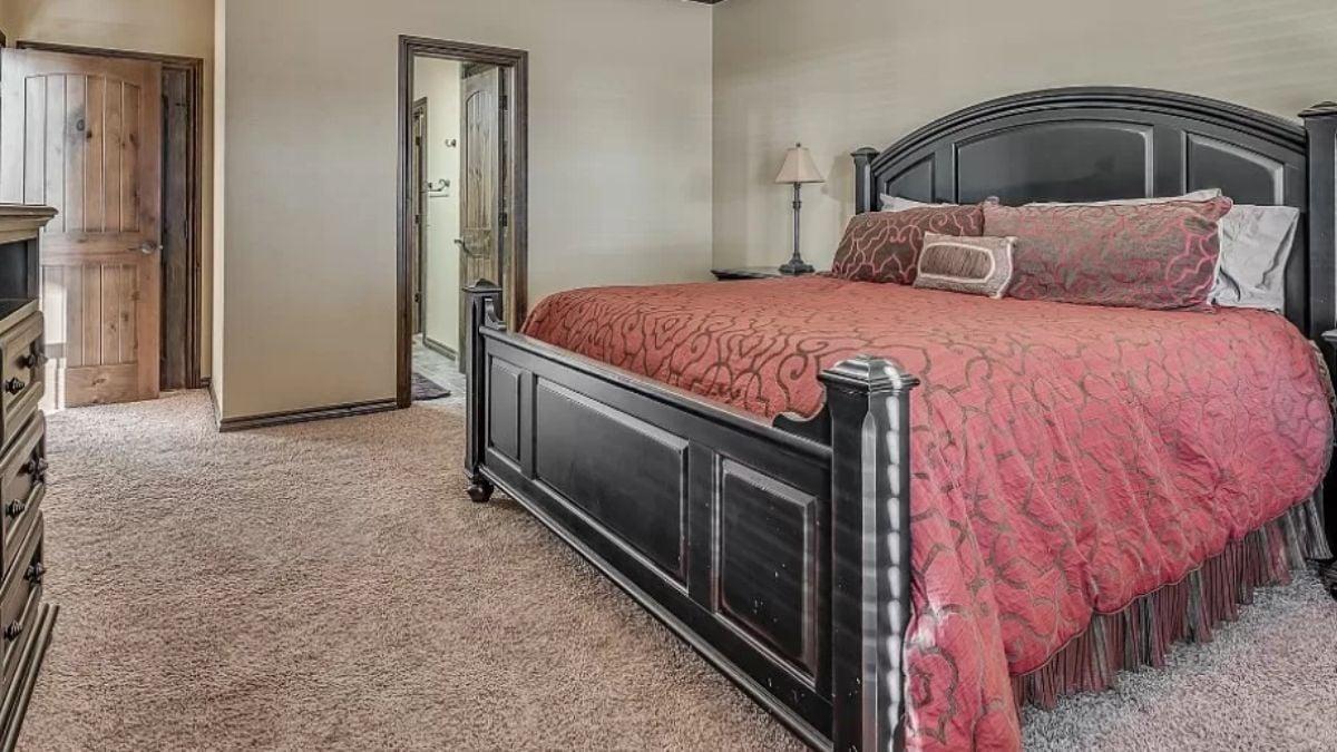 Notice the Striking Black Bed Frame in This Warm Bedroom