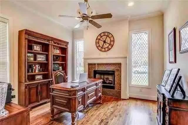 Notice How the Rich Wood Desk Anchors This Classic Study