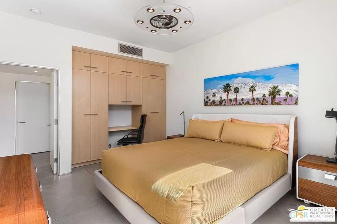 Chic Bedroom With Integrated Workspace and Scenic Art
