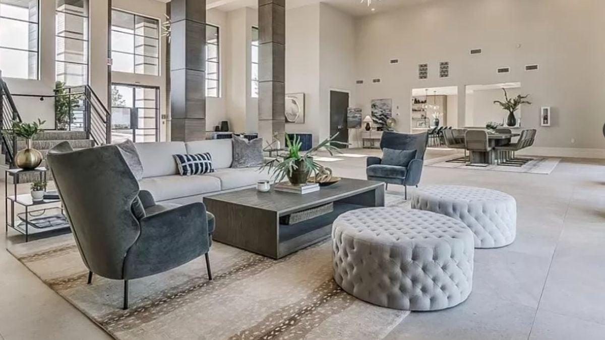 Explore This Expansive Living Area With Chic Tufted Ottomans