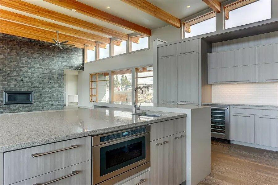 Kitchen with Bold Wooden Beams and Stone Feature Wall