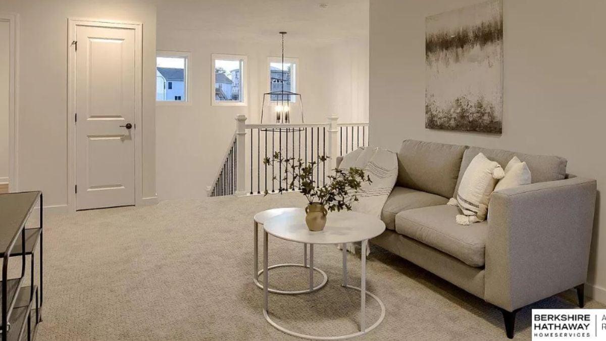 Relax in This Upper-Level Loft with Cozy Seating and Clean Lines