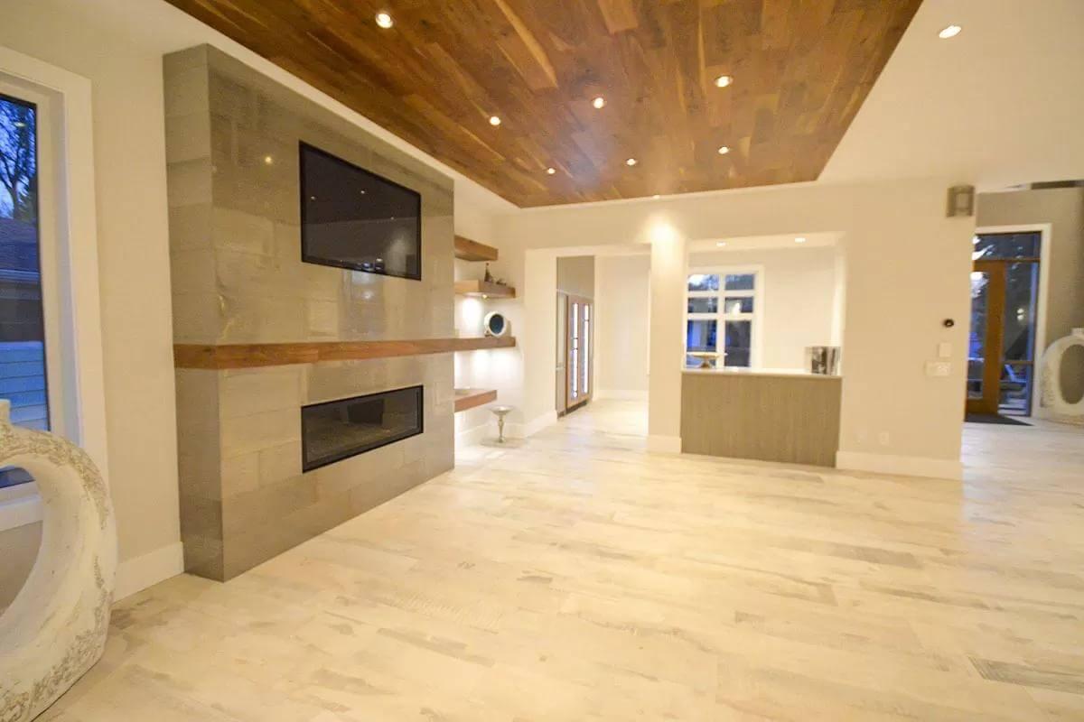 Open Living Space with Sleek Fireplace and Wooden Ceiling Details