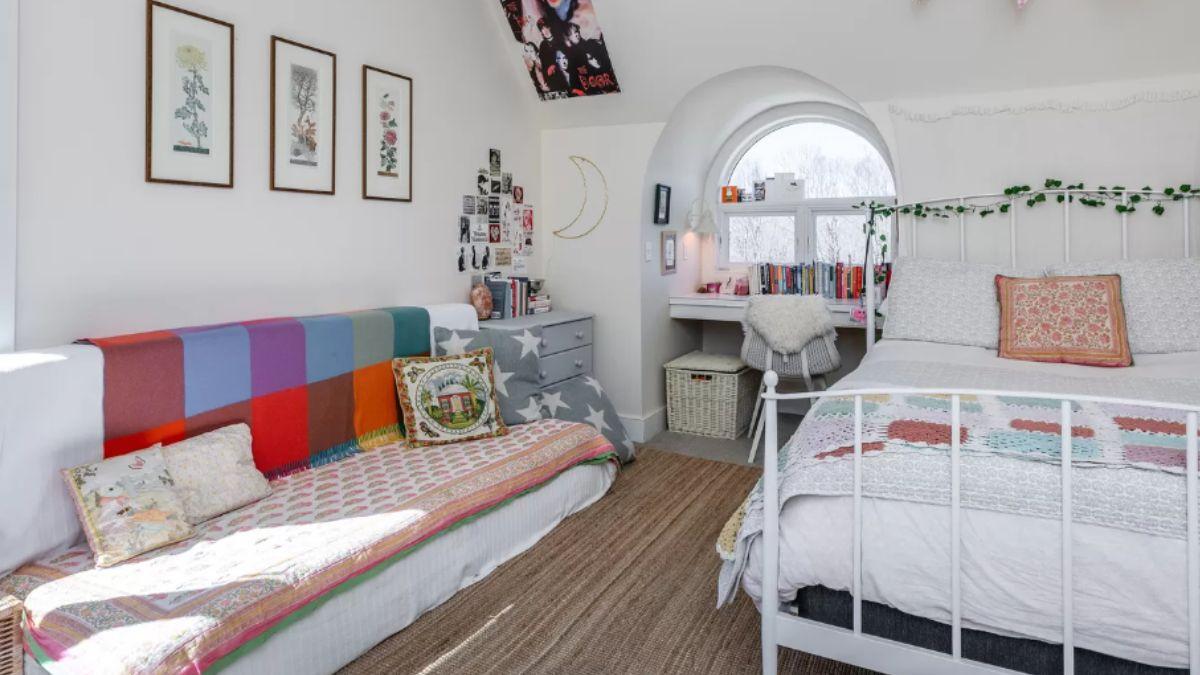 Charming Bedroom with Arched Window and Eclectic Textiles