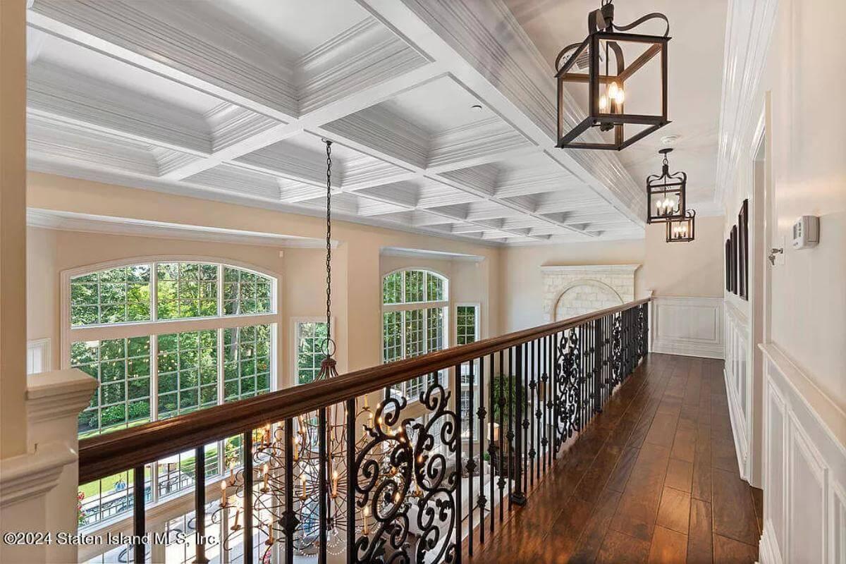 Take in the Coffered Ceiling and Elegant Ironwork on This Upper Landing