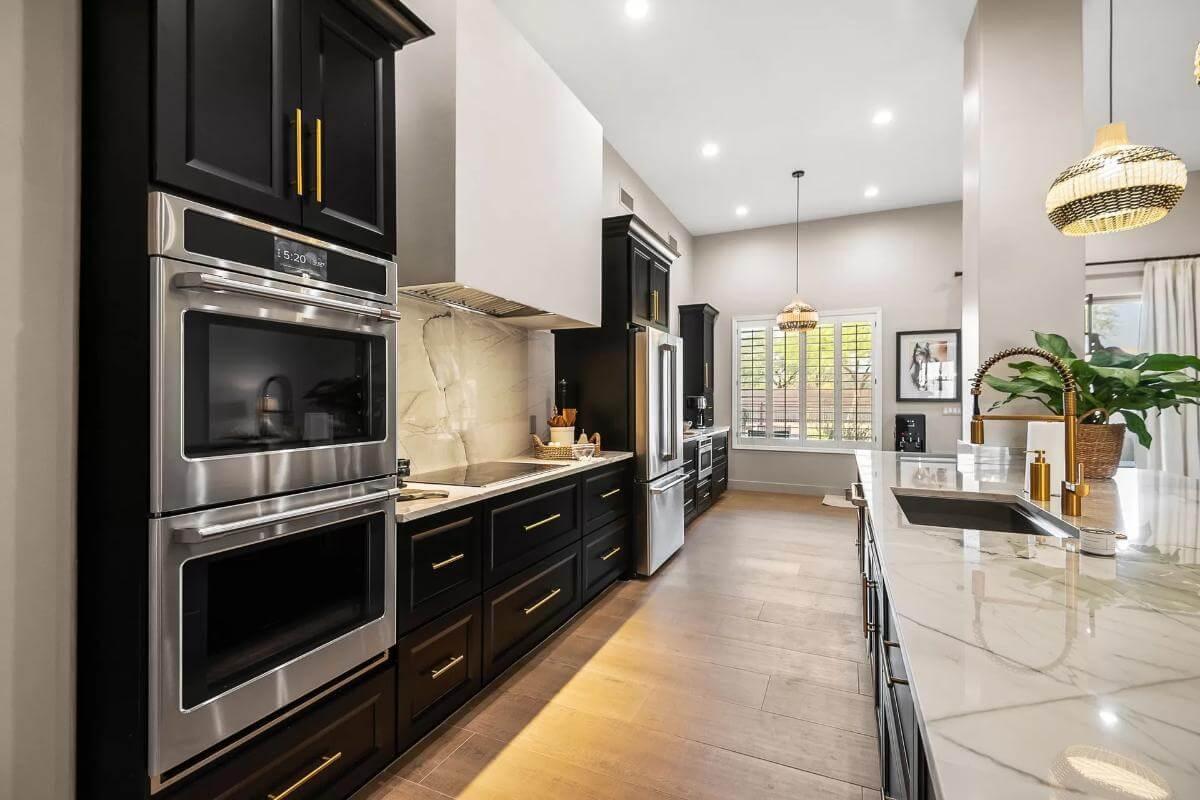 Explore the Sleek Dual Ovens and Marble Countertops in This Modern Kitchen