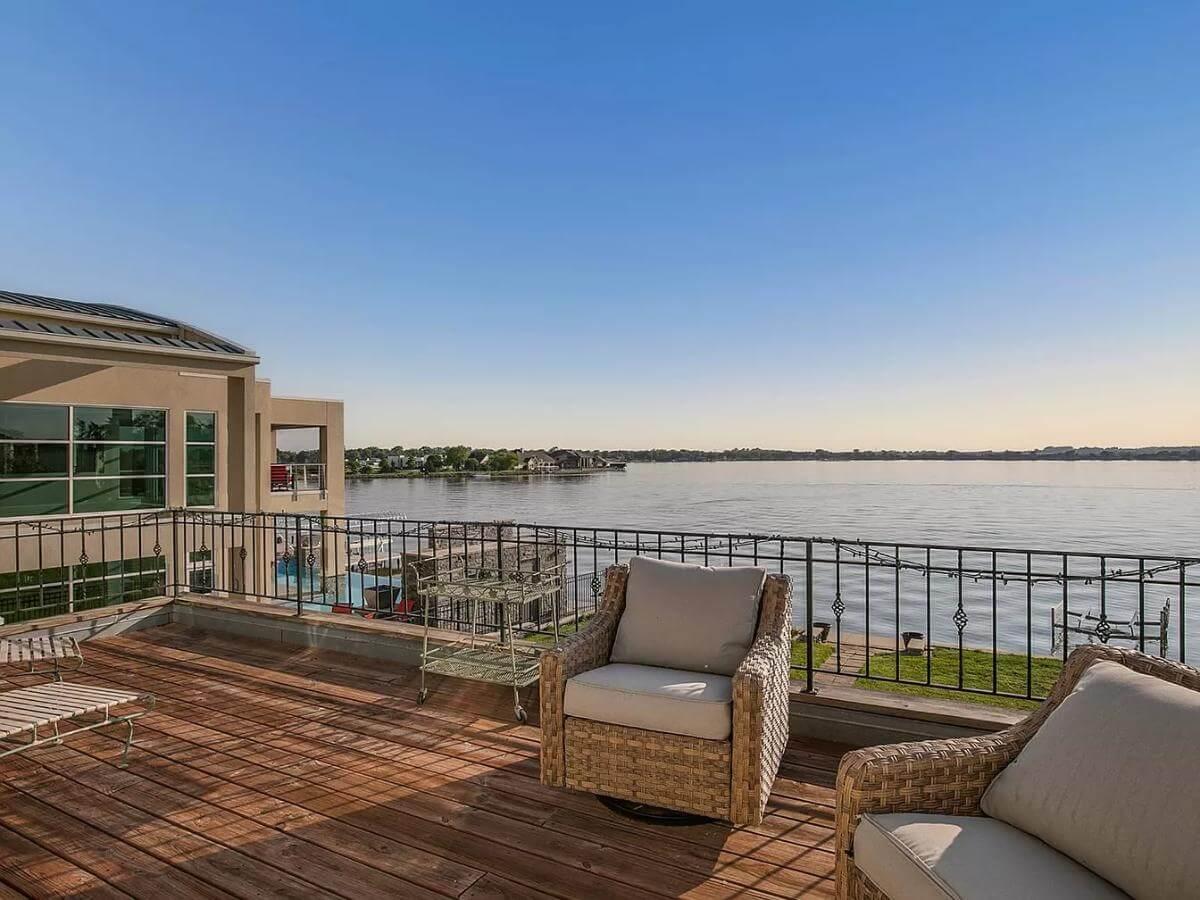 Relax on This Lakeside Balcony with Wicker Seating
