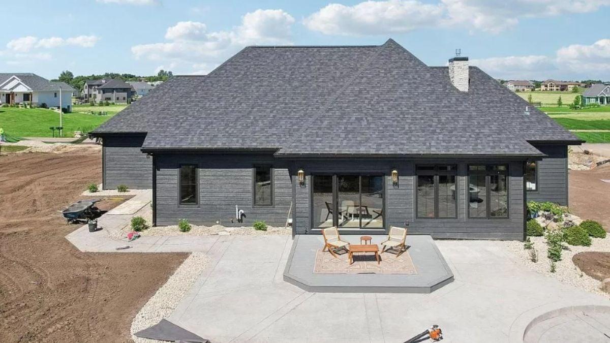 Notice the Simple Patio Design Against Bold Dark Siding